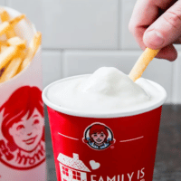 Hand dipping fry in Wendy's frosty.