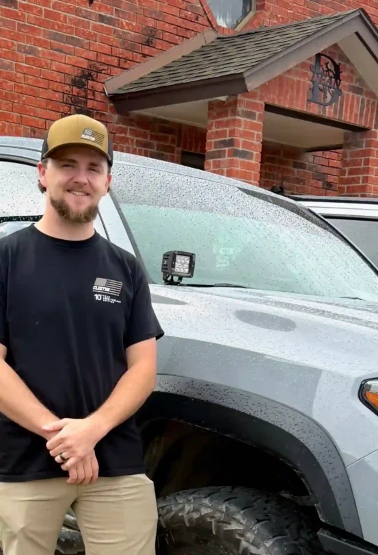 Man standing in front of truck.
