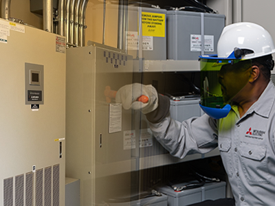 Technician testing pure lead batteries with UPS.